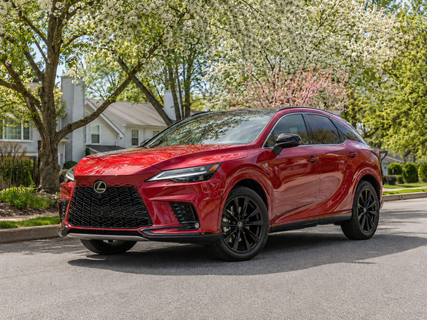 Red sports sedan parked on a tree-lined residential street