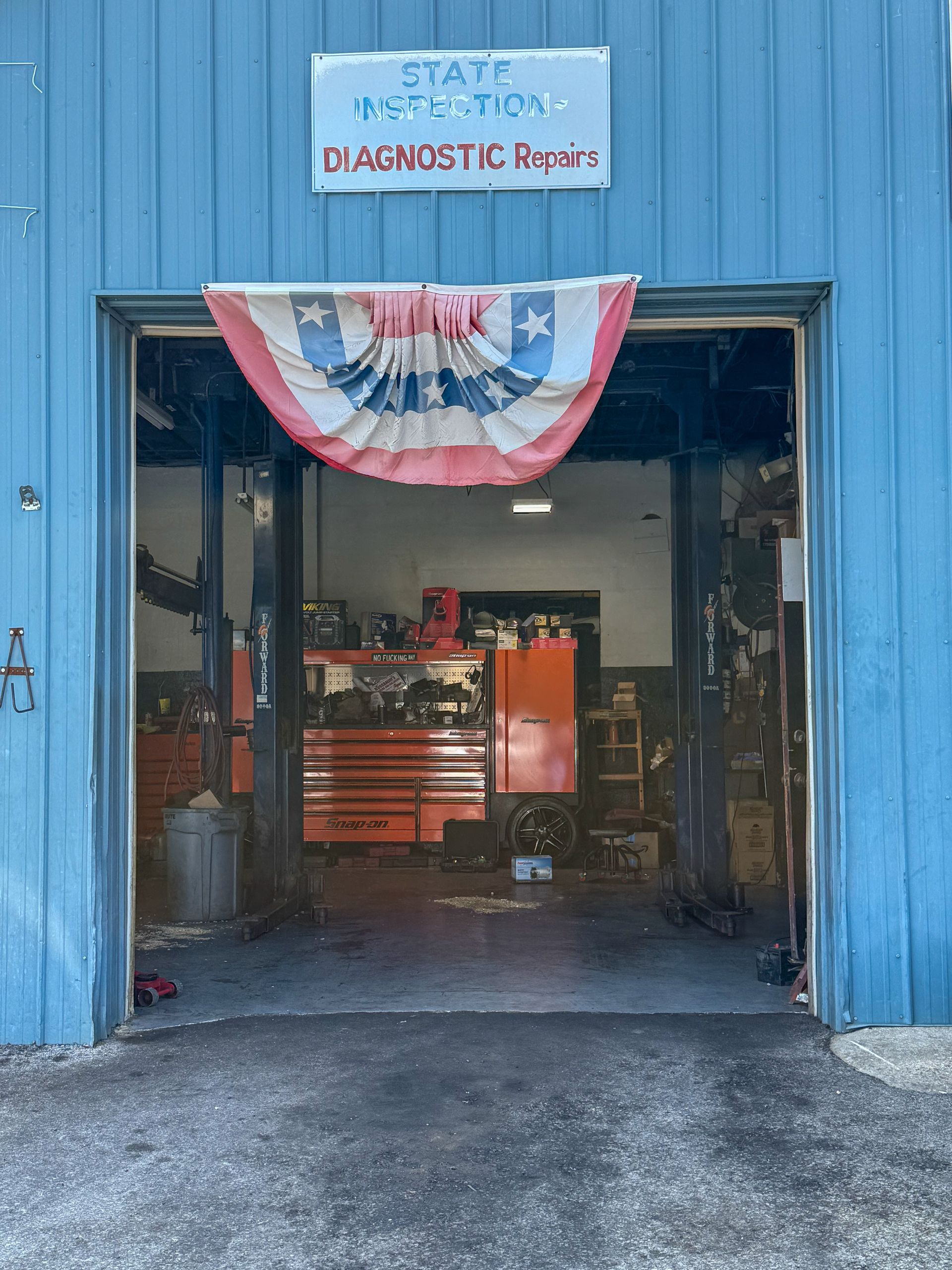 Briarcliffe Auto Service shop interior with a tool box, tools, and equipment.