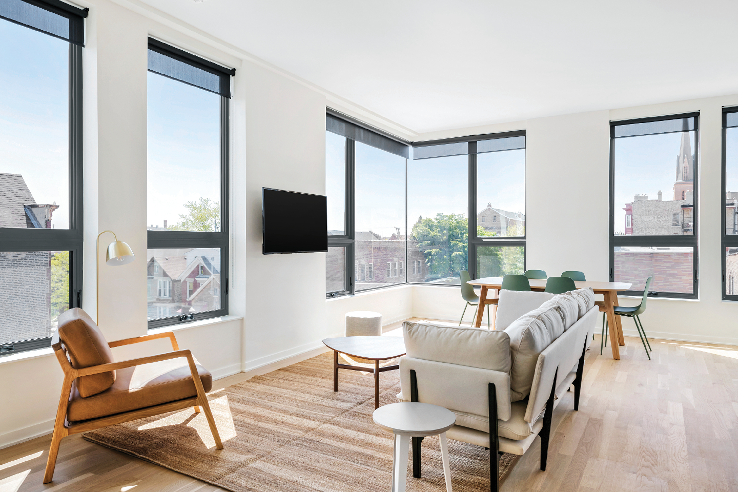 A living room with a couch , chair , table and television.