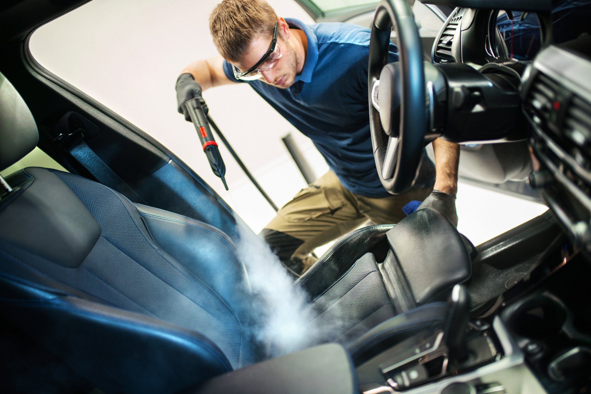 Man cleaning car interior — Ann Arbor, MI — A2 Auto Image Man cleaning car interior — Ann Arbor, MI — A2 Auto Image