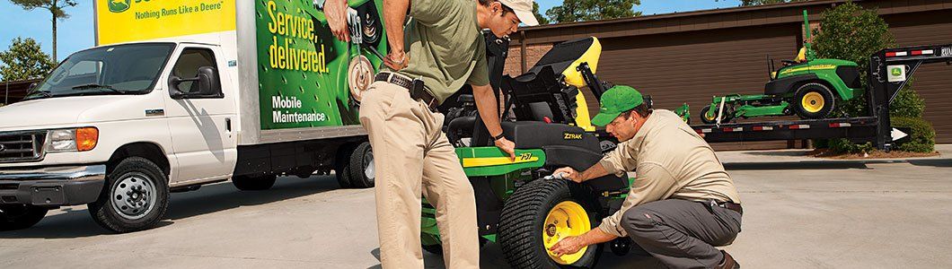 Deere technician working on a machine