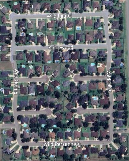An aerial view of a residential area with lots of houses and trees