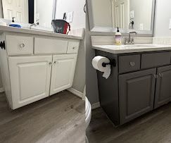 Bathroom vanity cabinets shown in white and dark gray side-by-side with countertop and mirror