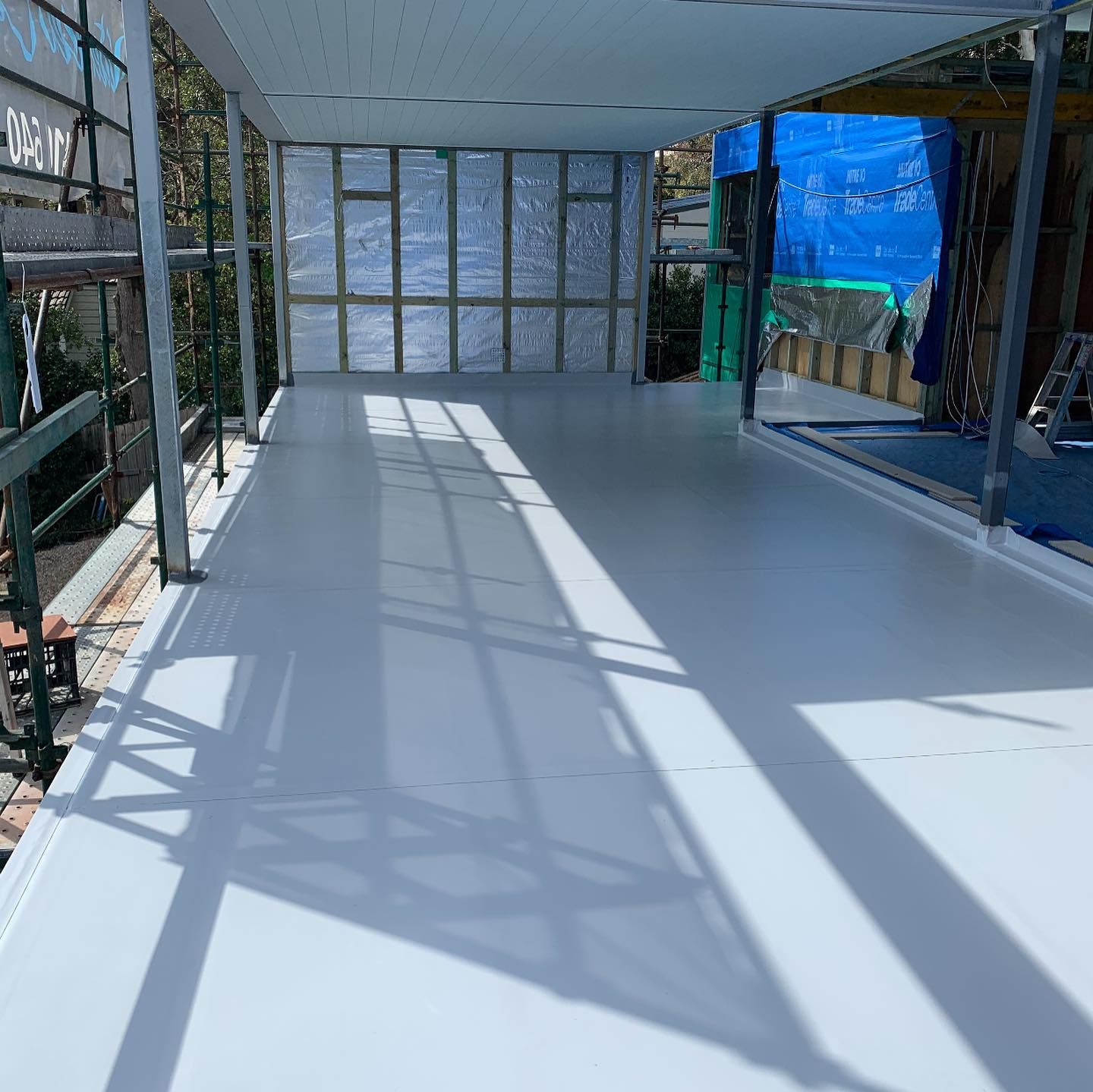 A White Floor With A Shadow Of A Scaffolding On It — Coastwide Waterproofing in Hornsby, NSW