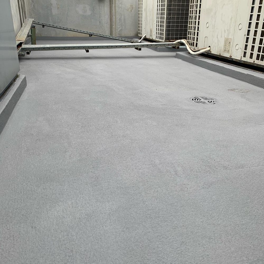 A Gray Concrete Floor With A Drain In The Middle Of It — Coastwide Waterproofing in Narrabeen, NSW