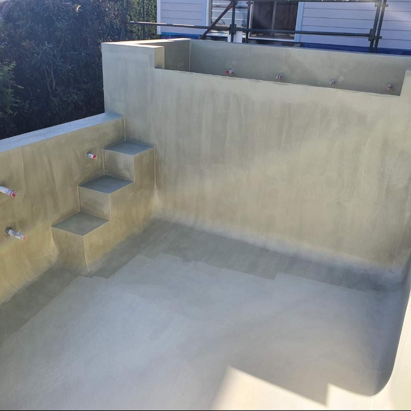A Concrete Wall With Stairs Leading Up To It — Coastwide Waterproofing in Killarney Vale, NSW