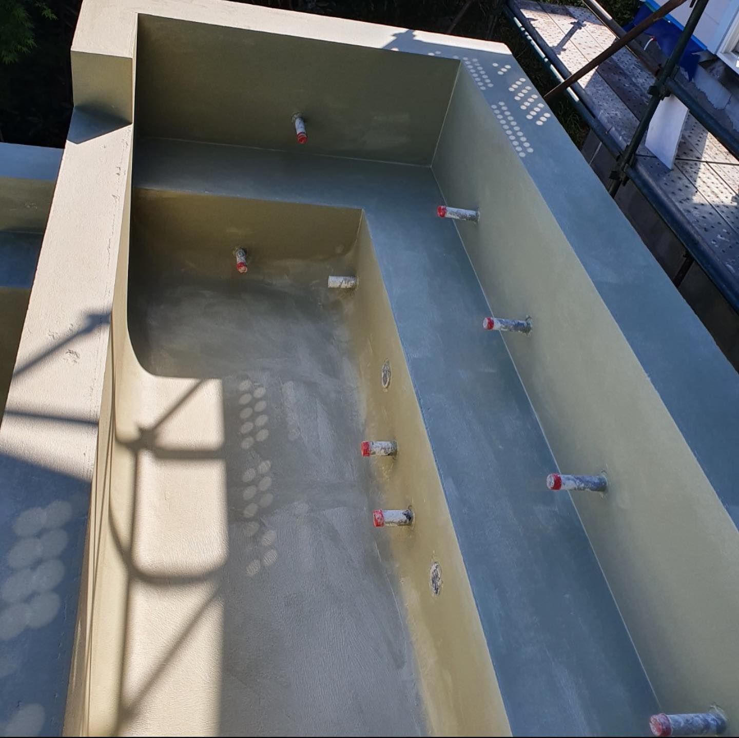 A Concrete Wall With A Few Bottles Of Paint On It — Coastwide Waterproofing in West Gosford, NSW