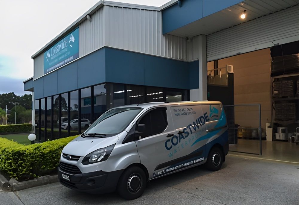 A White Van Is Parked In Front Of A Building — Coastwide Waterproofing in Narrabeen, NSW