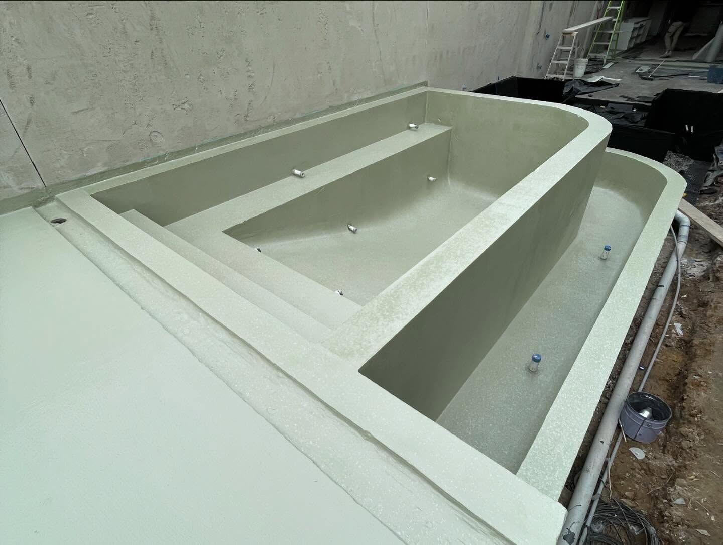 A Large White Swimming Pool Is Being Built In A Building — Coastwide Waterproofing in Narrabeen, NSW