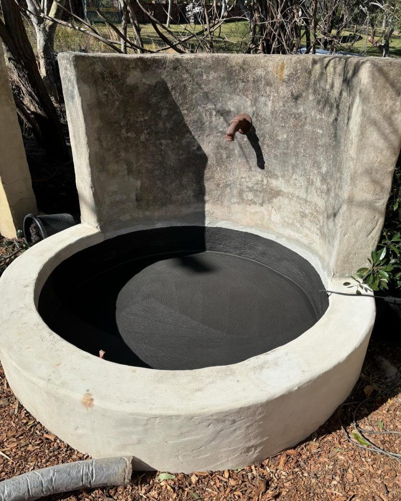 A Large Concrete Bowl Is Sitting On The Ground Next To A Wall — Coastwide Waterproofing in West Gosford, NSW