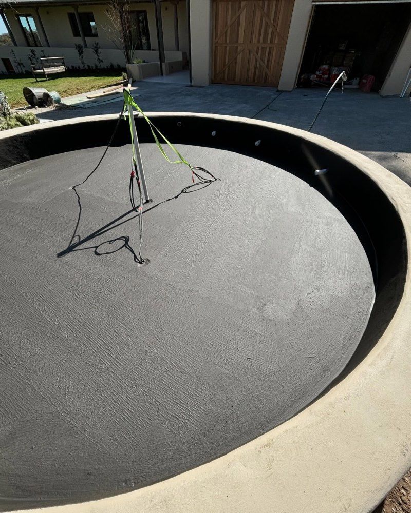 A Large Circular Object Is Sitting In Front Of A House — Coastwide Waterproofing in West Gosford, NSW