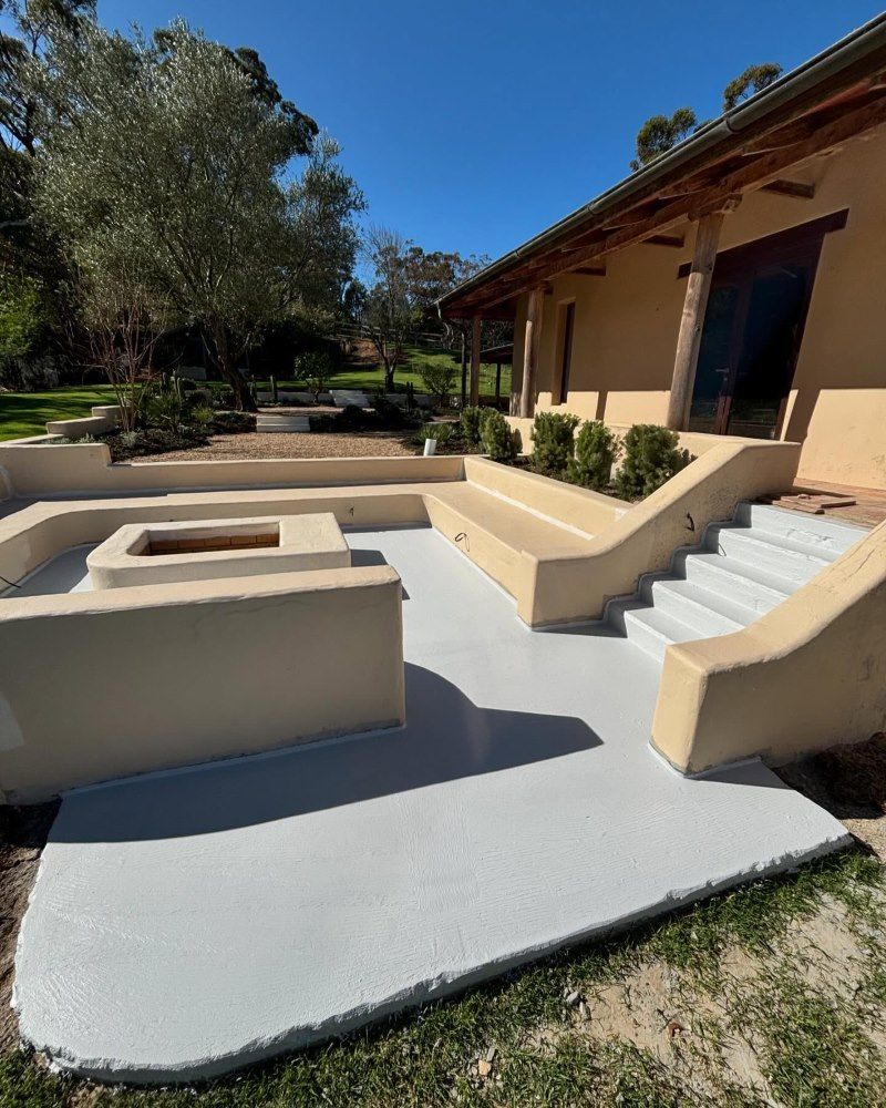 A Patio With A Fire Pit And Stairs In Front Of A House — Coastwide Waterproofing in Narrabeen, NSW