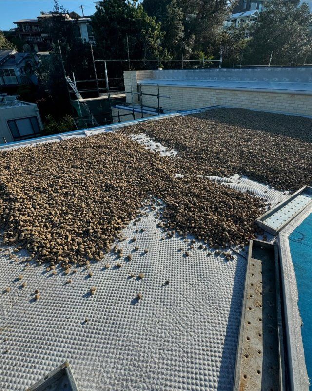A Roof With A Lot Of Rocks On It — Coastwide Waterproofing in Woy Woy, NSW