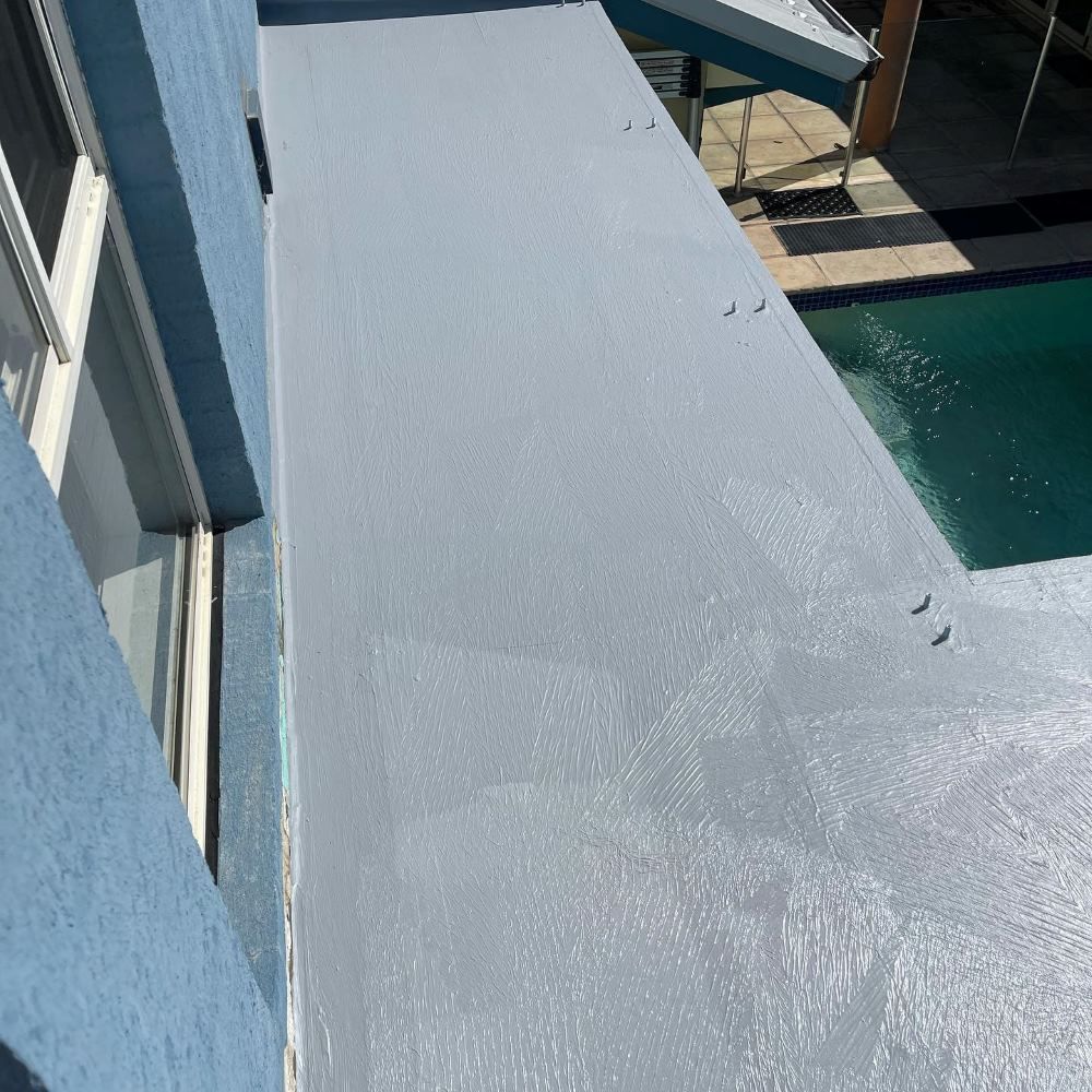 A Balcony With A Swimming Pool In The Background — Coastwide Waterproofing in Terrigal, NSW