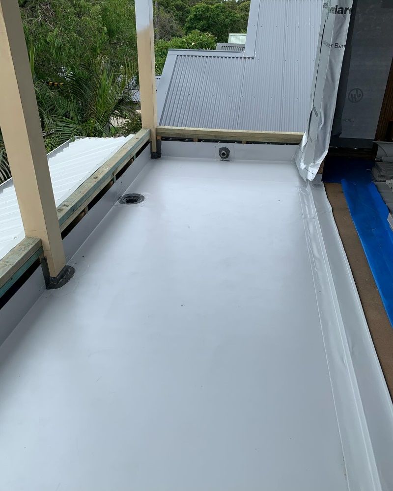 A White Roof Is Being Painted On A Balcony — Coastwide Waterproofing in Terrigal, NSW