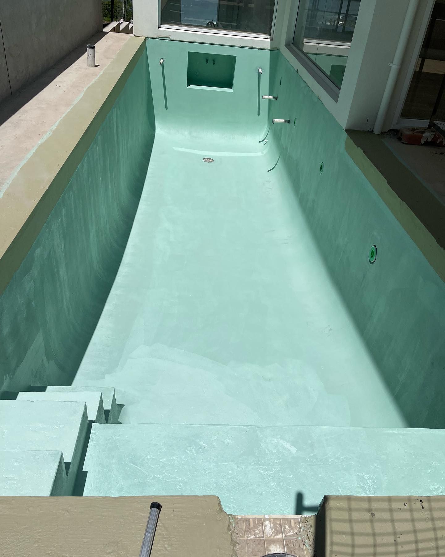 A Swimming Pool That Is Being Built And Has A Window In The Middle — Coastwide Waterproofing in West Gosford, NSW
