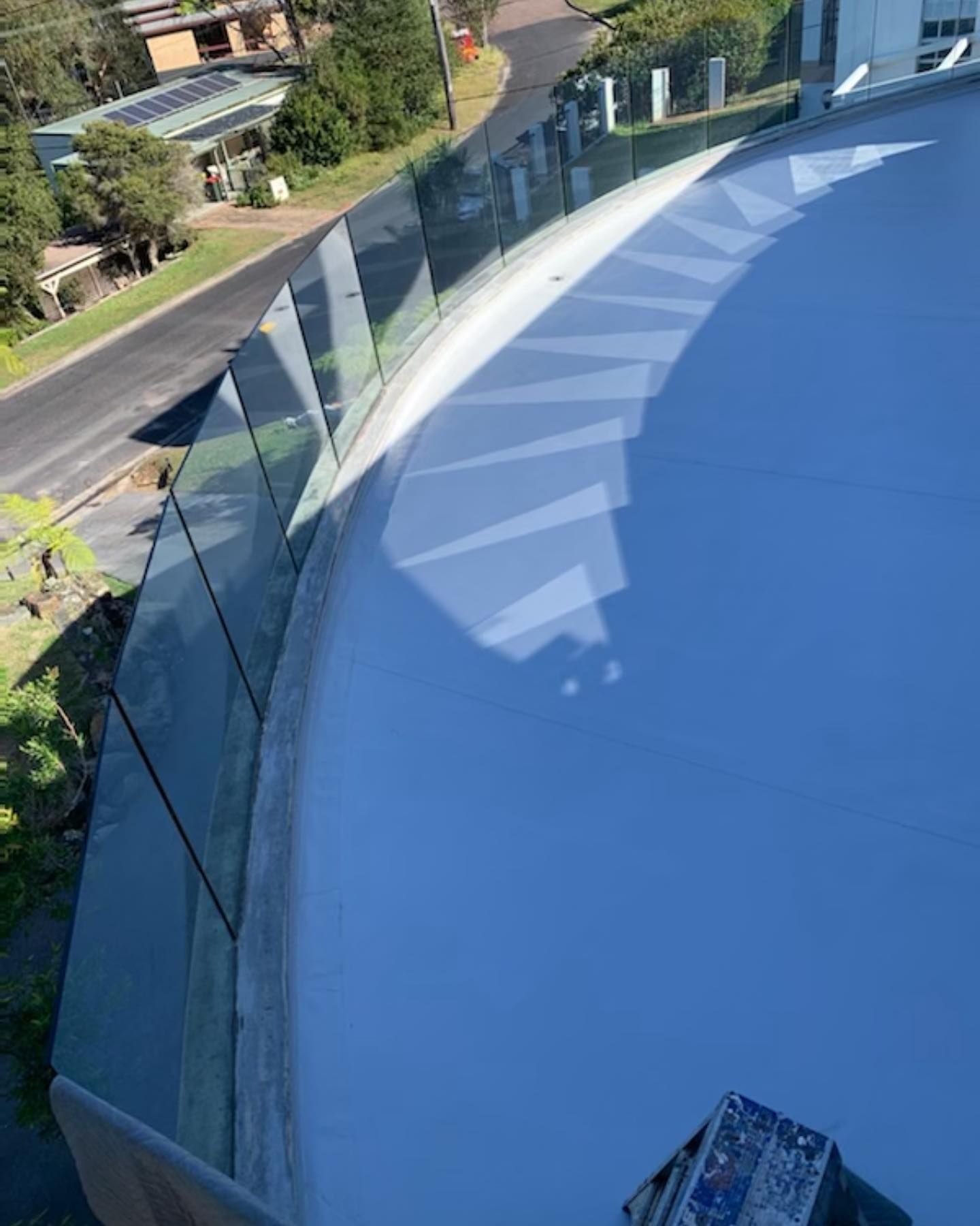 A Close Up Of A Glass Railing On A Balcony — Coastwide Waterproofing in Woy Woy, NSW