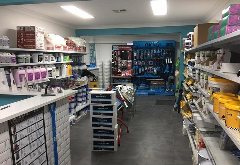 A Store Filled With Lots Of Shelves And Bottles Of Paint — Coastwide Waterproofing in Terrigal, NSW