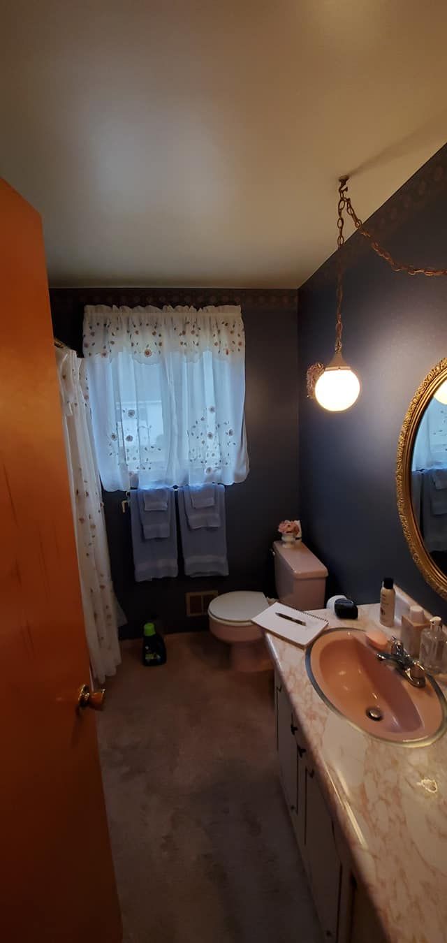 A bathroom with a sink , toilet , and mirror.