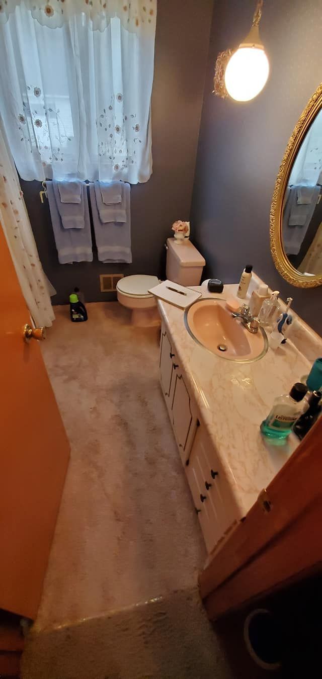 A bathroom with a sink , toilet , and mirror.