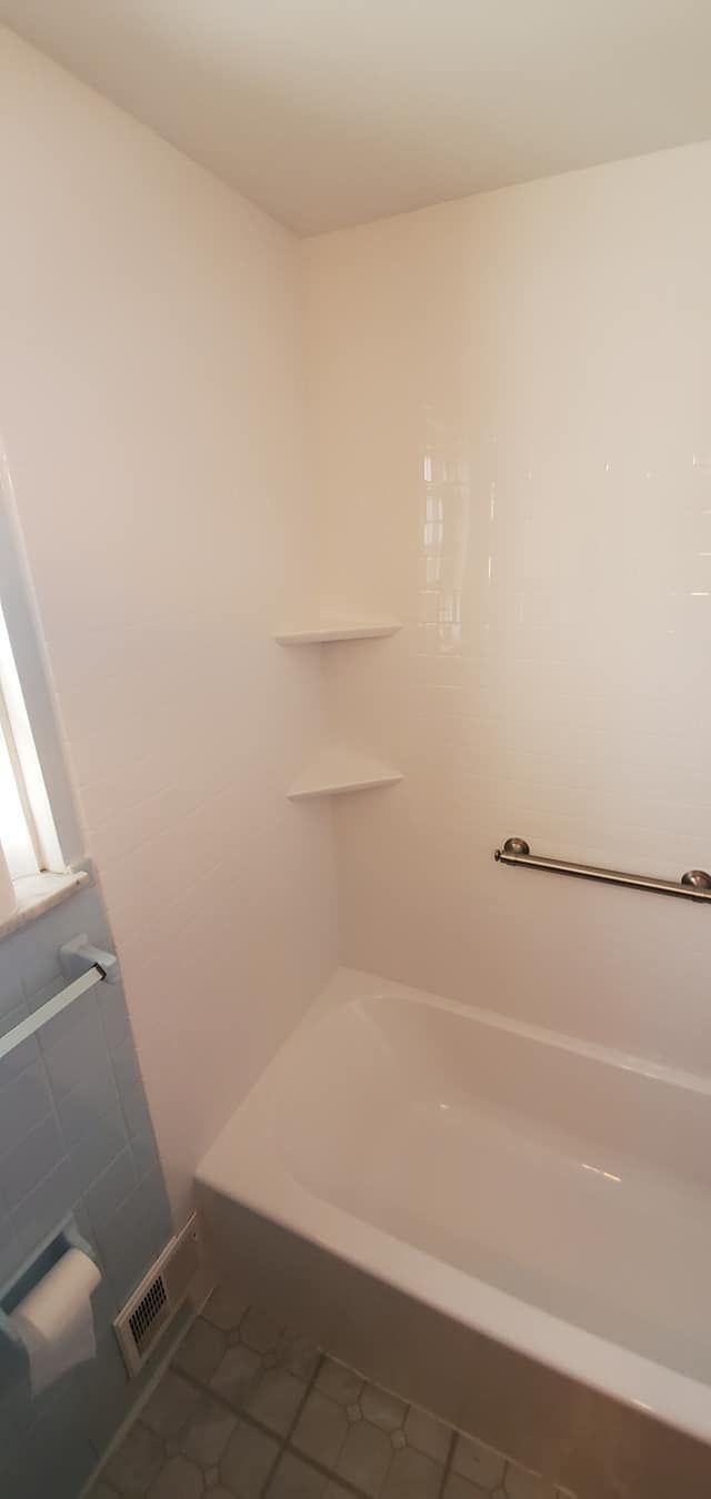 A bathroom with a bathtub and a toilet.