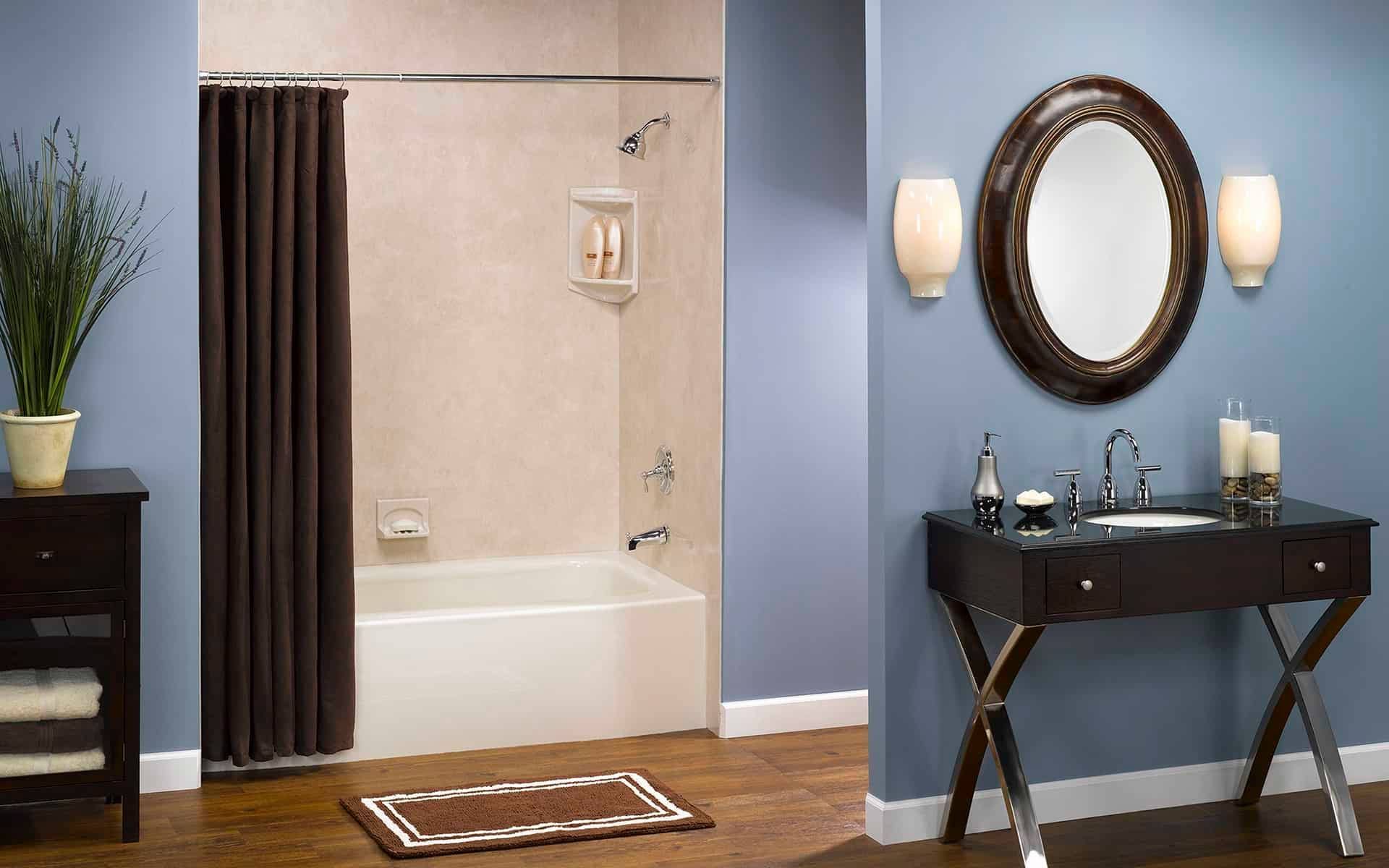 A bathroom with a tub a sink and a mirror
