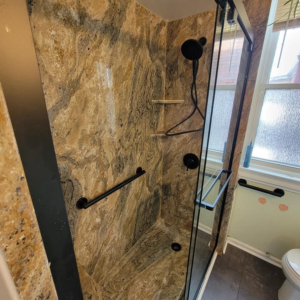 A bathroom with a walk in shower and a toilet