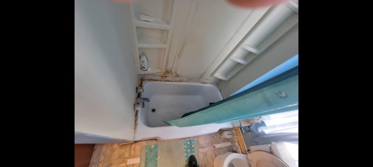 A bathroom with a bathtub and a toilet.