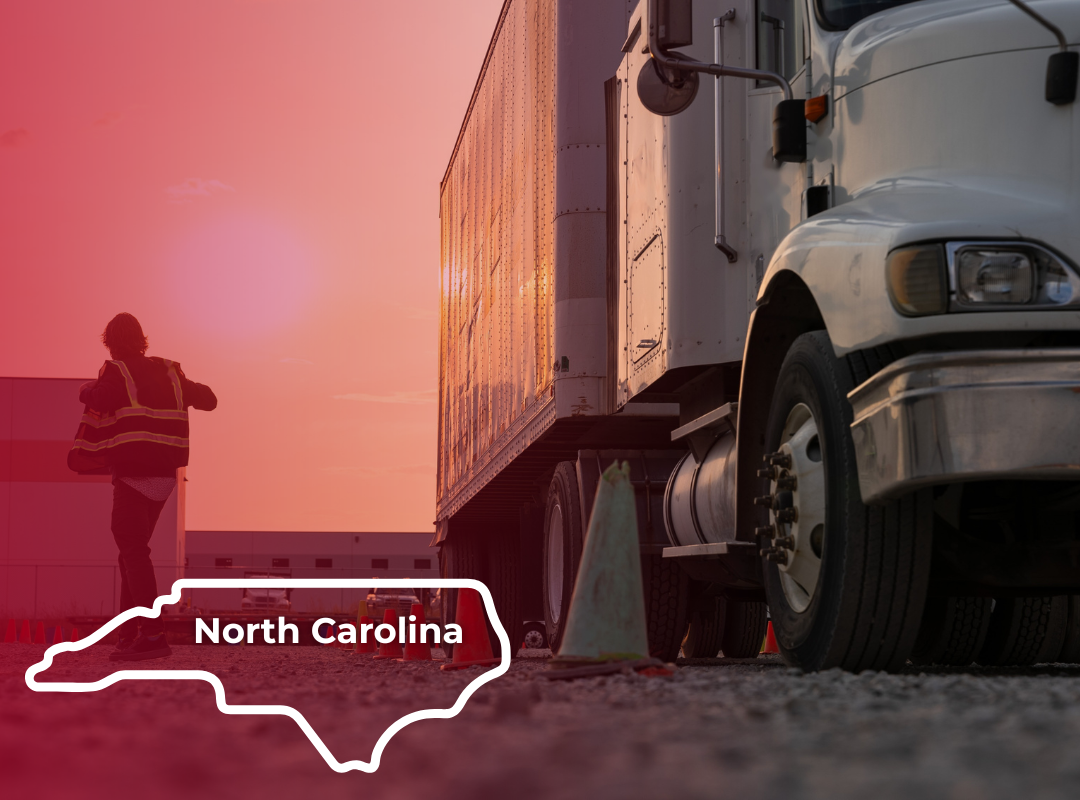 A CDL instructor in a reflective vest stands in an outdoor training lot with a semi-truck