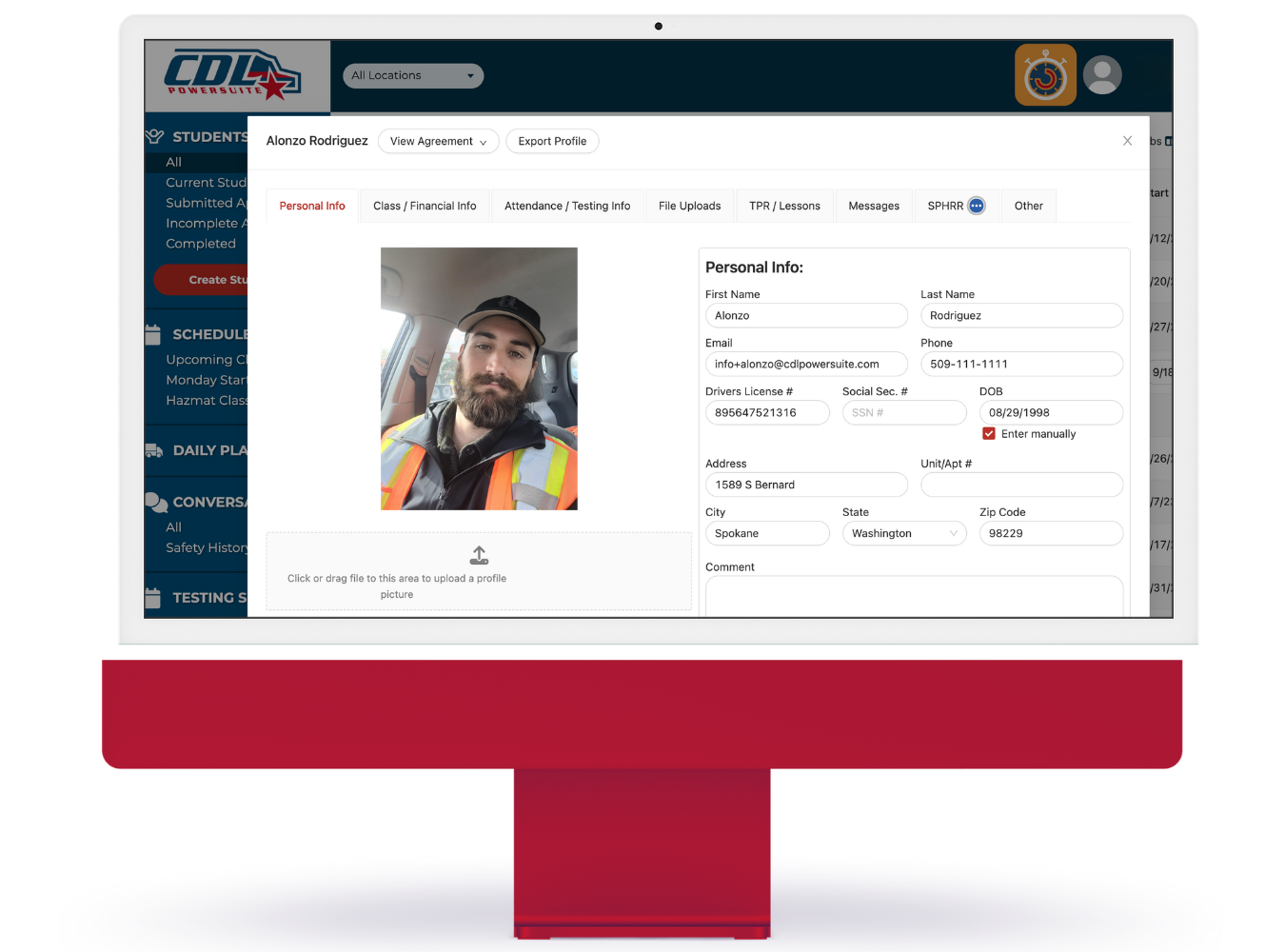 A computer monitor displaying a driver profile page on the CDL Dashboard website, featuring a photo of a person in a vest.