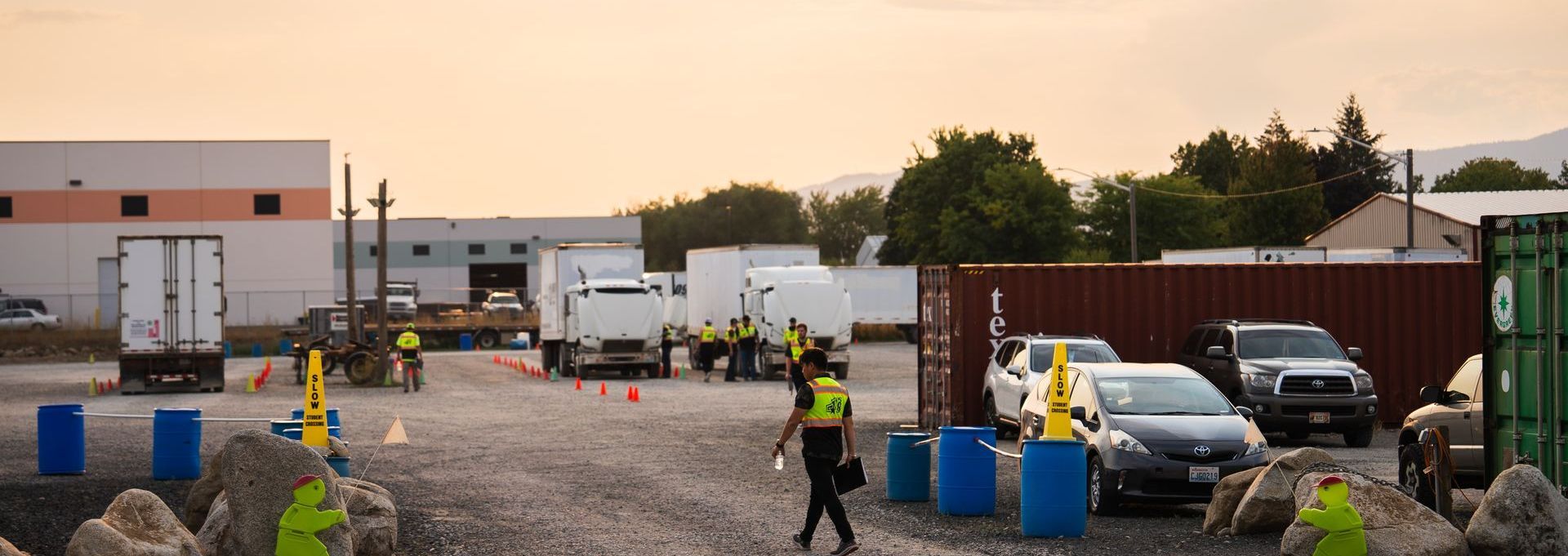 A group of CDL training students/trainees in a CDL training yard reviewing a semi-truck
