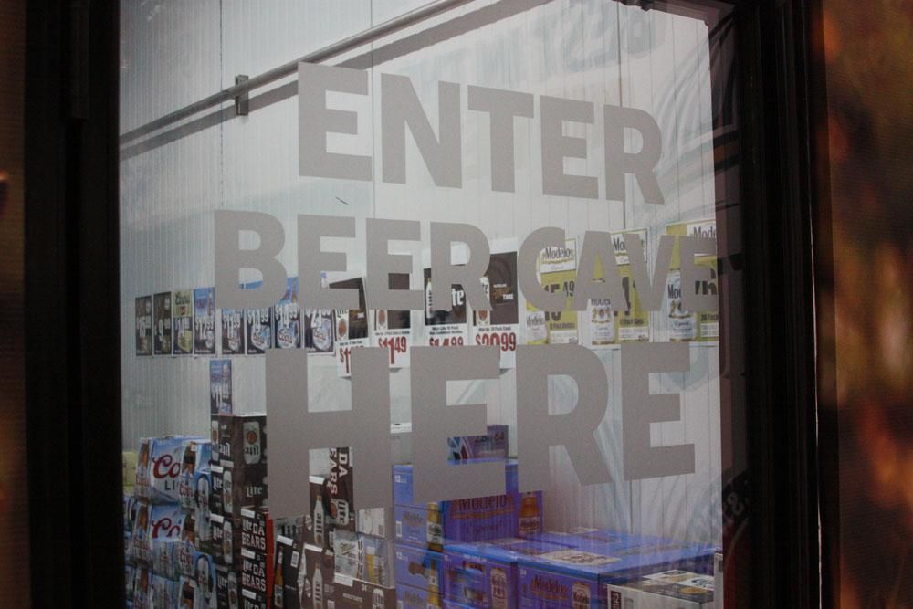 A glass door with white text that reads