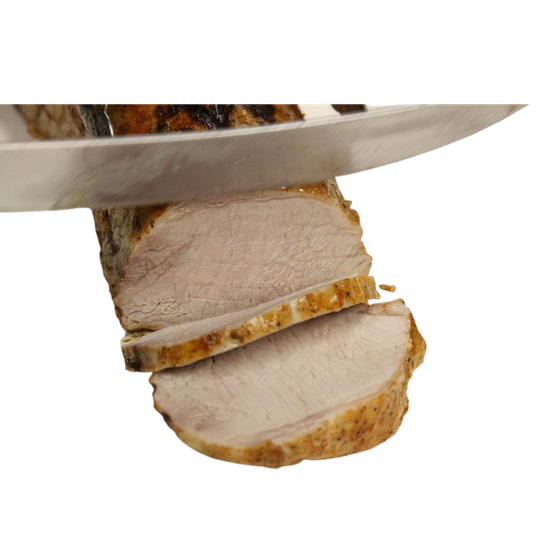 A sharp knife slices through a cooked pork tenderloin, separating a thin, golden-brown piece of meat from the roast.