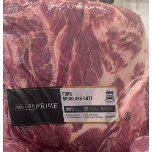 A vacuum-sealed package of raw USA Prime pork shoulder butt with a label featuring the brand name and product description.