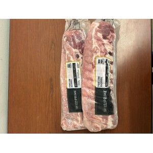 Two vacuum-sealed packages of raw pork ribs labeled