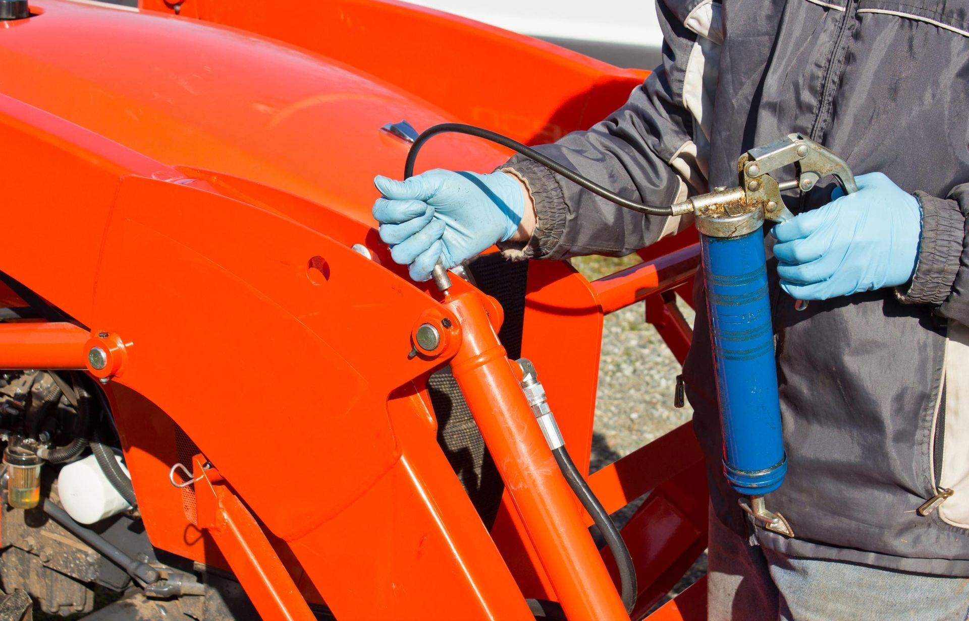 Greasing tractor — Elberta, AL — Elberta Pump Repair & Well Drilling, Inc.