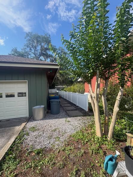 Dark gray slatted fence in front of white shutters Dark gray slatted fence in front of white shutters