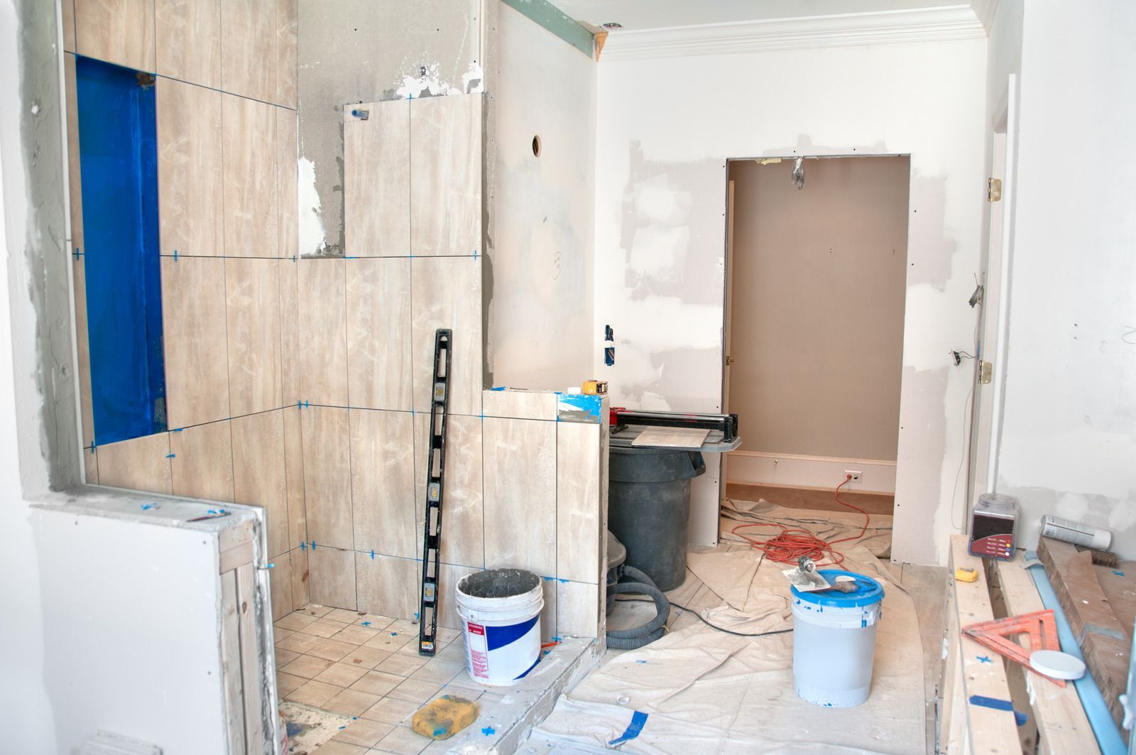 A room is being remodeled with tiles and a level.