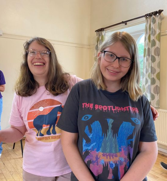 Girl wearing orange PWSA tee-shirt smiling