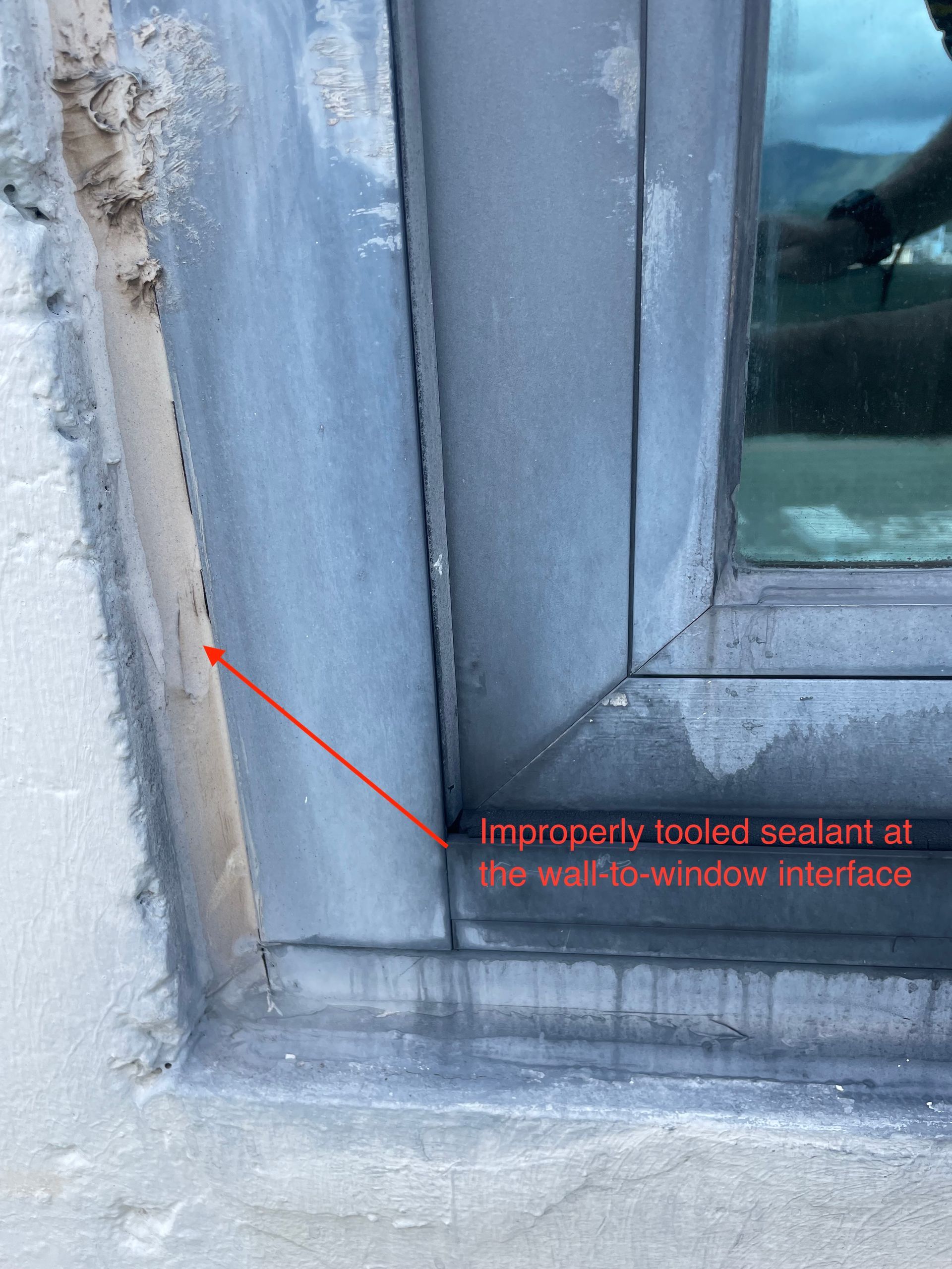Improperly tooled sealant at wall-to-window interface