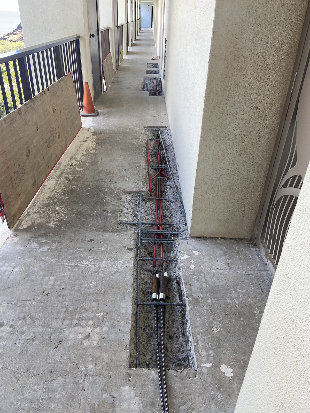 A concrete walkway with a metal bar in the middle of it.