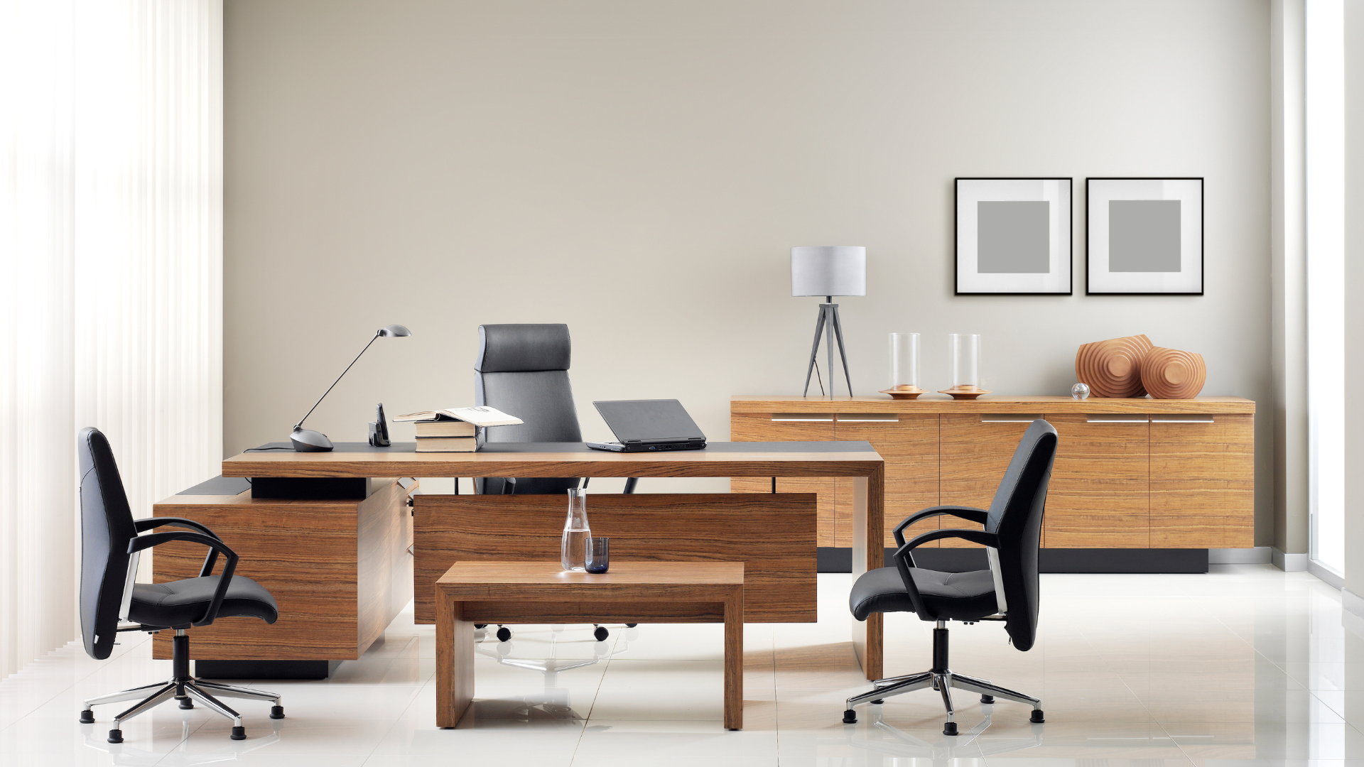 A modern office with a wooden desk and chairs.
