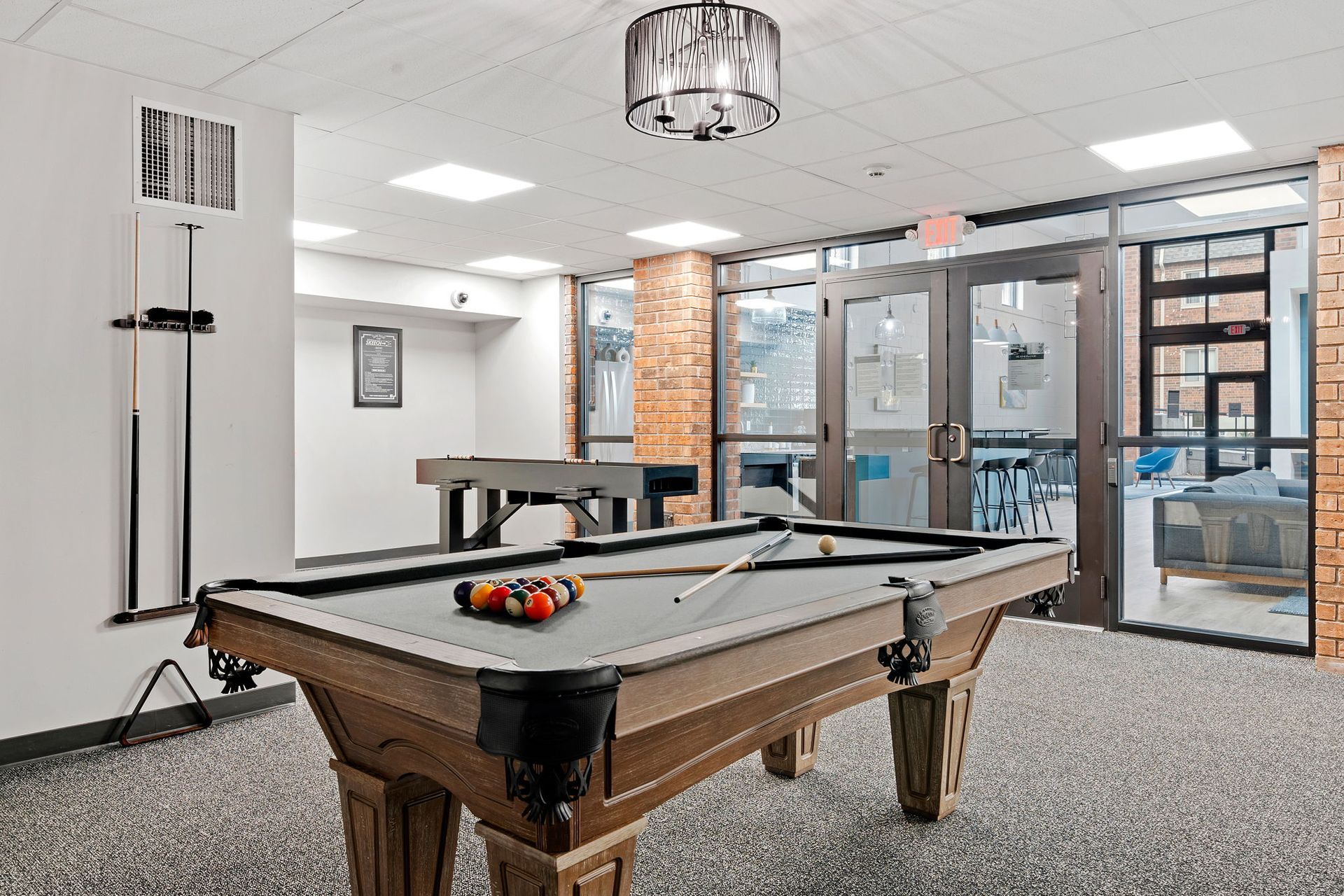 There is a pool table in the middle of the room.