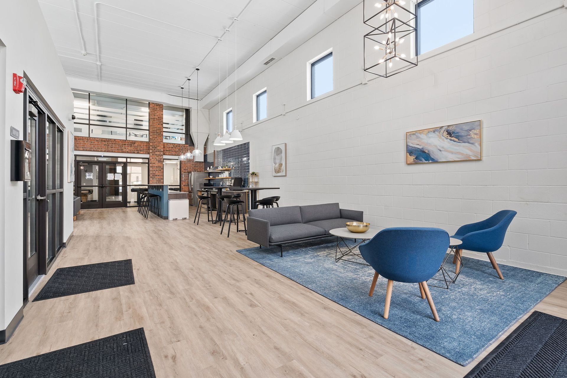 A living room with a couch , chairs , and a rug.