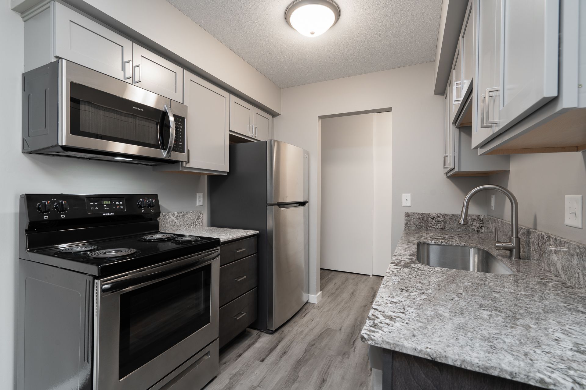 A kitchen with stainless steel appliances and granite counter tops