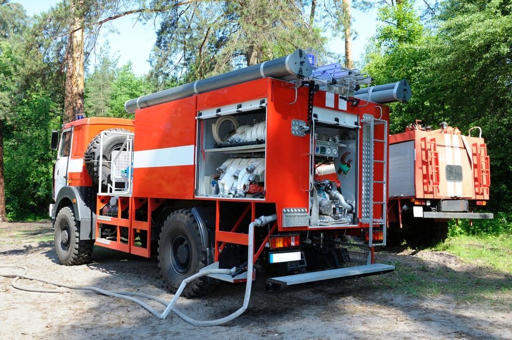 Two Fire Trucks Are Parked Next To Each Other In The Woods — ABC Driving School Central Coast In Umina Beach, NSW