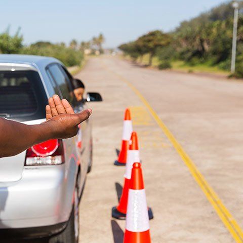 A Person Standing Next To A Car With Their Hand Out The Window — ABC Driving School Central Coast In Umina Beach, NSW