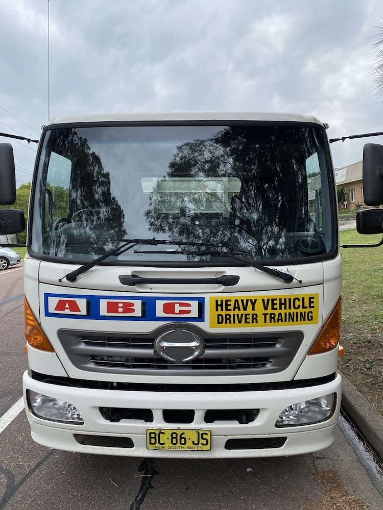 A Heavy Vehicle Driver Training Truck Is Parked On The Side Of The Road — ABC Driving School Central Coast In Umina Beach, NSW