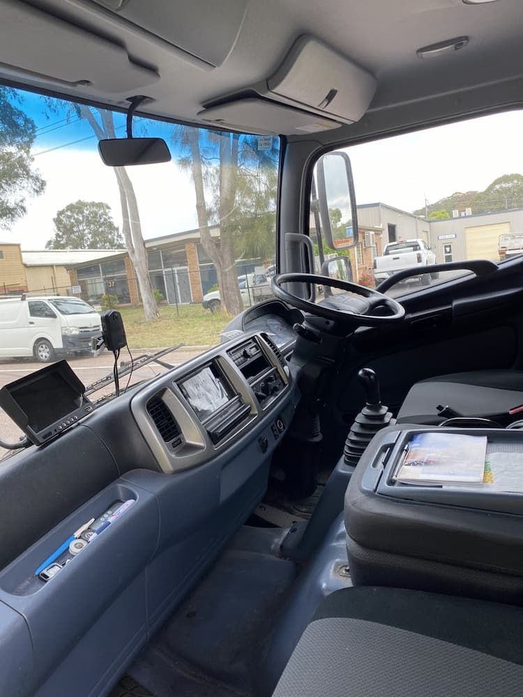 The Inside Of A Truck With A Steering Wheel And Dashboard — ABC Driving School Central Coast In Umina Beach, NSW