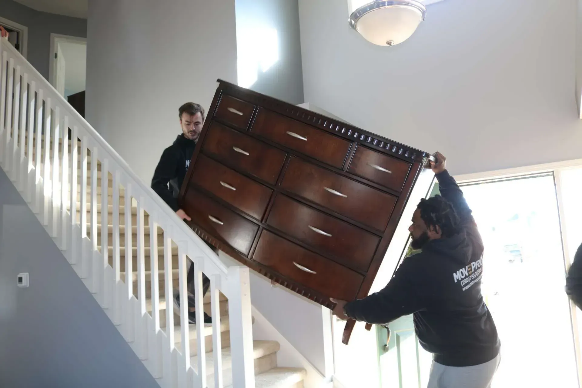 MovePro movers carefully transporting a piano during a specialty move in Fort Wayne